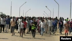 Sudanese demonstrators march and chant during a protest against the military takeover, in Atbara, Sudan, October 27, 2021, in this social media image.