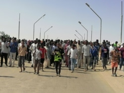 Sudanese demonstrators march and chant during a protest against the military takeover, in Atbara, Oct. 27, 2021, in this social media image.