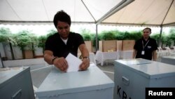 Seorang warga Indonesia yang tinggal di Malaysia memasukkan surat suara ke dalam kotak suara yang tersedia di Kedutaan Besar Indonesia di Kuala Lumpur, Malaysia, 9 April 2009