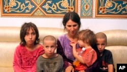 FILE - Abeer Shalgheen and her four children were among 19 women and children hostages held by the Islamic State group July 25.
