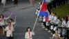 FILE - Cambodian flag-bearer Davin Sorn leads her nation's contingent in the athletes parade during the opening ceremonies of the London 2012 Olympic Games at Olympic Stadium, July 27, 2012. 