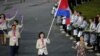 Cambodia's flagbearer Davin Sorn holds the national flag as she leads the contingent in the athletes parade during the opening ceremony of the London 2012 Olympic Games at the Olympic Stadium July 27, 2012. REUTERS/Mike Blake