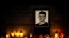 Candles and a portrait of Slovak investigative journalist Jan Kuciak