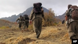 FILE - Rebels of the Kurdistan Workers Party, PKK, in Turkey close to the border with Iraq, May 7, 2013.