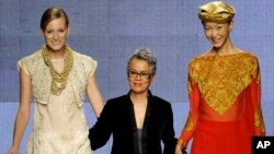 FILE - Pakistani designer Maheen Khan, center, takes the catwalk during a fashion show in Milan, Italy, Sept. 30, 2009. 