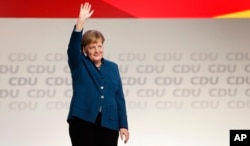 German Chancellor and chairwoman of the German Christian Democratic Union (CDU), Angela Merkel, waves after her farewell speech during a party convention of the CDU in Hamburg, Germany, Dec. 7, 2018.