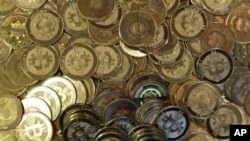 FILE - A pile of bitcoin tokens are shown April 2013.