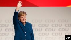 German Chancellor and chairwoman of the German Christian Democratic Union (CDU), Angela Merkel, waves after her farewell speech during a party convention of the CDU in Hamburg, Germany, Dec. 7, 2018. 