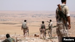 FILE - Fighters allied with Syria Democratic Forces (SDF) are seen near Manbij, northern Syria, June 1, 2016. Turkmen commander Hani al-Mulla was losely affiliated with the SDF.