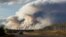 Smoke billows from the Fort McMurray wildfires as a truck drives down the highway in Kinosis, Alberta, Canada, May 5, 2016. 