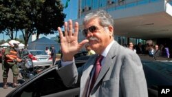 FILE - Argentina's then Planning Minister Julio de Vido waves to media as he leaves the Ministry of Mines and Energy in Brasilia, Brazil, April 20, 2012. De Vido was charged, April 1, 2018, in a case investigating corruption involving the Brazilian company Odebrecht. 