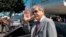 FILE - Argentina's then Planning Minister Julio de Vido waves to media as he leaves the Ministry of Mines and Energy in Brasilia, Brazil, April 20, 2012. De Vido was charged, April 1, 2018, in a case investigating corruption involving the Brazilian company Odebrecht. 