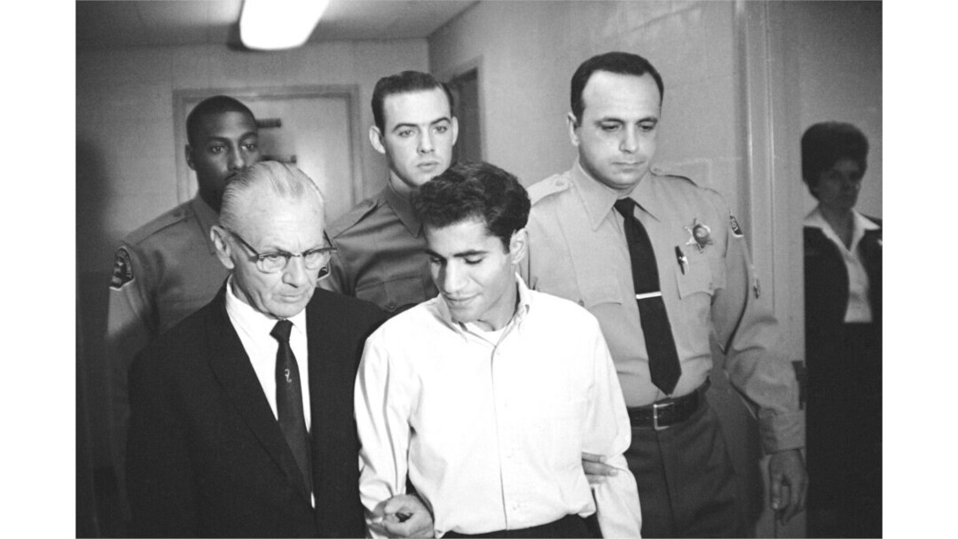 FILE - Sirhan Sirhan is escorted by his attorney, Russell E. Parsons, from Los Angeles County Jail's chapel to enter a plea to a charge of murder in Los Angeles, in the fatal shooting of Sen. Robert F. Kennedy, June 28, 1968.