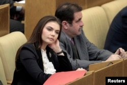 FILE - Former Olympic gymnast Alina Kabaeva, at the time deputy chair of the State Duma Committee for Youth Affairs is seen during a session of the State Duma, Russia's lower house of parliament, in Moscow, April 20, 2011.