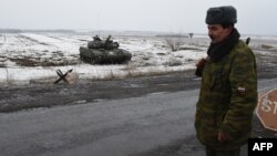 FILE - Pro-Russian separatist soldier guards checkpoint in Enakieve, 25 kilometers from the eastern Ukrainian city of Debaltseve, Jan. 29, 2015.