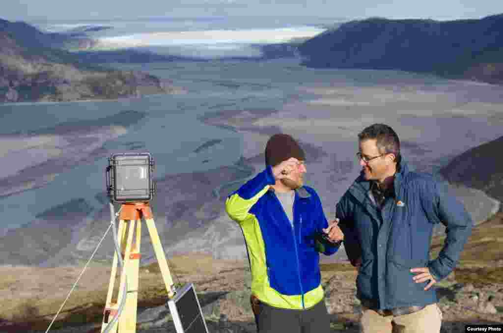 UCLA geography graduate student Lincoln Pitcher (left) and UCLA geography professor Laurence C. Smith overlook the mighty Isortoq River, where meltwater leaves the Greenland ice sheet to flow to the ocean seen in the distance. (UCLA/Laurence C. Smith)