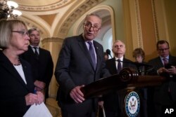 Senate Minority Leader Chuck Schumer, D-N.Y., joined by, from left, Sen. Patty Murray, D-Wash., Sen. Sheldon Whitehouse, D-R.I., and Sen. Jack Reed, D-R.I., responds to an announcement by Majority Leader Mitch McConnell that he intends to cancel the tradional August recess.