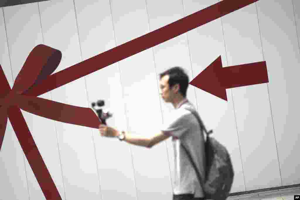 A man takes a selfie at the Ginza shopping district in Tokyo, Japan.