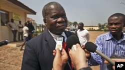 Head of the Central African Republic's government delegation to the peace talks, Jean Willybiro Sako, speaks to the media at the airport in Bangui, Central African Republic Monday, Jan. 7, 2013.