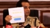 Mumbai police commissioner Hemant Nagrale displays a document as he addresses a press conference in Mumbai, India, Jan. 5, 2022. 