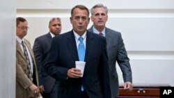 Ketua DPR AS John Boehner, R-Ohio, bersama anggota DPR dari Partai Republik Kevin McCarthy, berjalan menuju ruang pertemuan di gedung Capitol (15/10). (AP/J. Scott Applewhite)