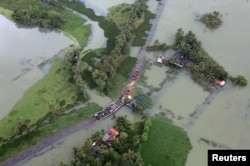 An aerial view shows partially submerged road at a flooded area in the southern state of Kerala, India, Aug. 19, 2018.