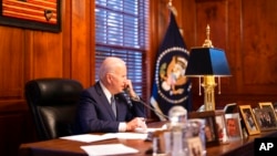 In this image provided by the White House, President Joe Biden speaks with Russian President Vladimir Putin on the phone from his private residence in Wilmington, Del., Dec. 30, 2021. (Adam Schultz/The White House via AP)