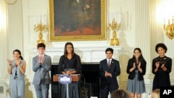 First Lady Michelle Obama hosts a poetry reading in honor of the 2016 National Student Poets, from left: Maya Salameh, Joey Reisberg, Gopal Raman, Maya Eashwaran and Stella Binion in the State Dining Room of the White House on Thursday, Sept. 8, 2016 in W