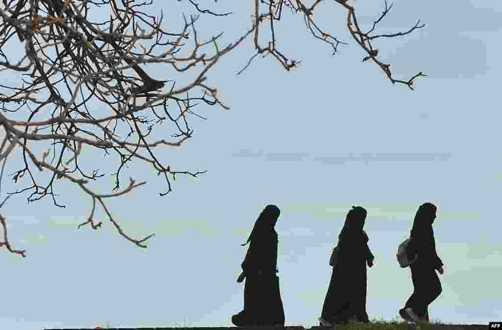 Muslim women walk at the Galle Fort in the bay of Galle on the southwest coast of Sri Lanka.