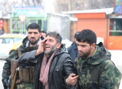 An Afghan man reacts near the site of a suicide attack in Kabul, Afghanistan February 11, 2020.