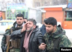 An Afghan man reacts near the site of a suicide attack in Kabul, Afghanistan February 11, 2020.