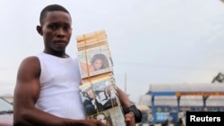A boy sells a music CD along a road in NIgeria's city of Port-Harcourt.