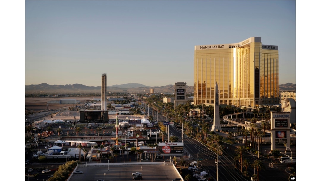 The Mandalay Bay resort and casino, right, overlooks an outdoor festival grounds across the street, left, Tuesday, Oct. 3, 2017, in Las Vegas. Authorities said Stephen Craig Paddock broke the windows on the casino and began firing with a cache of weapons,