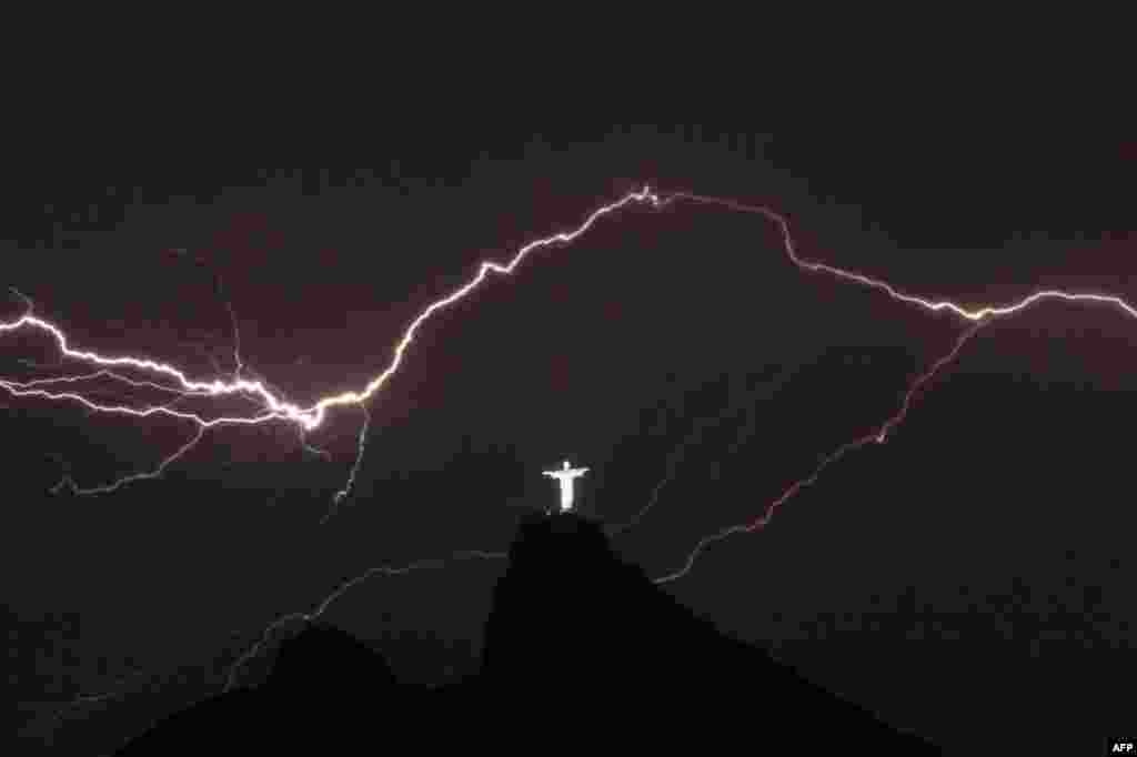 Lightning flashes over the Christ the Redeemer statue on top of Corcovado Hill in Rio de Janeiro, Brazil.