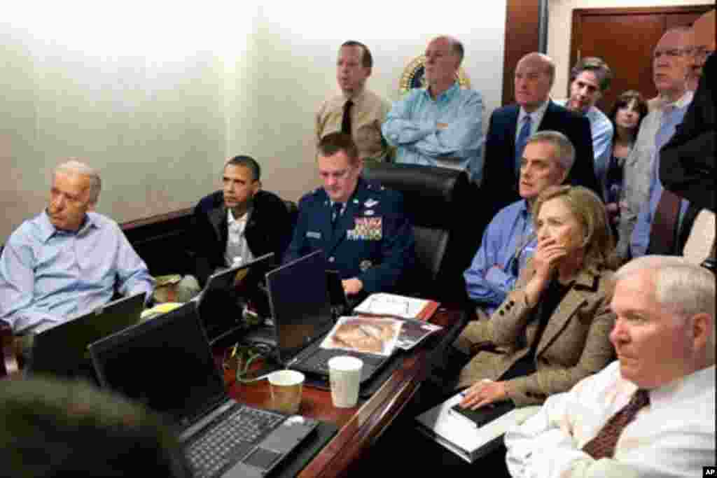 President Barack Obama and Vice President Joe Biden, along with members of the national security team, receive an update on the mission against Osama bin Laden in the Situation Room of the White House, May 1, 2011. Seated, from left, are: Brigadier Genera