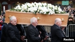 Pallbearers carry the coffin holding the remains of theoretical physicist Stephen Hawking out of Great St. Mary's Church at the conclusion of his funeral service, in Cambridge, Britain, March 31, 2018.