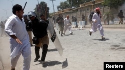 Police officers use batons to disperse protesters during a demonstration against the constitutional amendment bill for the merger of Federally Administered Tribal Areas (FATA) with Khyber Pakhtunkhwa (KPK) province, outside the assembly building in Peshawar, Pakistan, May 27, 2018.