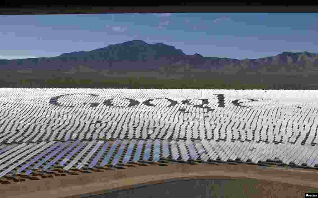 The Google logo is spelled out in heliostats (mirrors that track the sun and reflect the sunlight onto a central receiving point) during a tour of the Ivanpah Solar Electric Generating System in the Mojave Desert near the California-Nevada border, USA. The project, a partnership of NRG, BrightSource, Google and Bechtel, is the world&#39;s largest solar thermal facility and uses 347,000 sun-facing mirrors to produce 392 megawatts of electricity, enough energy to power more than 140,000 homes.