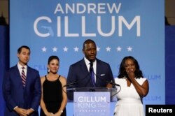 FILE - Democratic Florida gubernatorial nominee and Tallahassee Mayor Andrew Gillum concedes the race to U.S. Rep. Ron DeSantis as Gillum's running mate Chris King, left, King's wife Kristin, center, and Gillum's wife R. Jai watch at his side during his midterm election night rally in Tallahassee, Florida, Nov. 6, 2018.