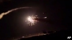 FILE - This frame grab from a video provided by the Syrian official news agency SANA shows missiles flying into the sky near Damascus, Syria, Dec. 25, 2018. Israeli warplanes flying over Lebanon fired missiles toward areas near the Syrian capital, Syrian state media reported.