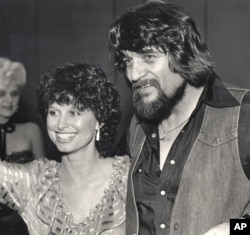 FILE - Country music legend Waylon Jennings, right, and his wife, country singer Jessi Colter, attend a party in Nashville, Tennessee, in July 1982.