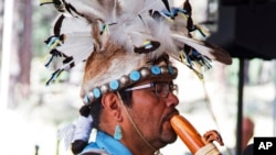 This 2017 photo provided by the Museum of Northern Arizona shows an unidentified man wearing a headpiece fashioned out of an animal hide at the Navajo Festival of Arts and Culture in Flagstaff, Ariz. (Ryan Williams/Museum of Northern Arizona via AP)