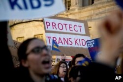 FILE - Activists and protesters with the National Center for Transgender Equality rally in front of the White House, Feb. 22, 2017.