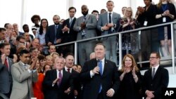 New Secretary of State Mike Pompeo (C), with wife Susan Pompeo, and son Nick Pompeo (R) is applauded after speaking to State Department employees as he arrives at the State Department in Washington, May 1, 2018. 