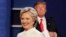 FILE - Democratic presidential nominee Hillary Clinton walks off stage as Republican presidential nominee Donald Trump puts his notes away after the third presidential debate at UNLV in Las Vegas, Oct. 19, 2016.