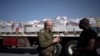 İsrail ordusundan Albay Moshe Tetro, Kerem Şalom sınır kapısında insani yardım taşıyan ve Gazze Şeridi’ne geçmek üzere bekleyen bir kamyonun önünde bir gazetecinin sorularını yanıtlıyor.