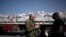 FILE - Israeli Army Colonel Moshe Tetro speaks to a journalist as trucks carrying humanitarian aid bound for the Gaza Strip wait in a holding area at Kerem Shalom Crossing on the border between Gaza and southern Israel on Jan. 10, 2024.