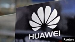 A Huawei logo is seen above the company's exhibition pavilion during the CommunicAsia information and communications technology trade show in Singapore on June 19, 2012.