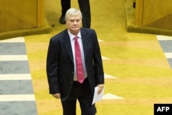 Leader of the conservative Afrikaner Freedom Front Pieter Groenewald joins newly elected Members of Parliament as they are sworn in for the 6th Democratic Parliament on May 22, 2019, in Cape Town.