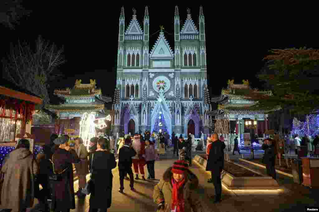 Worshippers walk in front of Xishiku Church, also known as the North Church, on Christmas Eve in Beijing, China, Dec. 24, 2024.